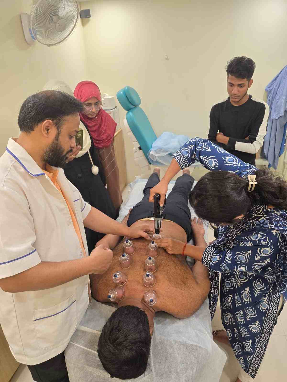 Students practising cupping therapy techniques